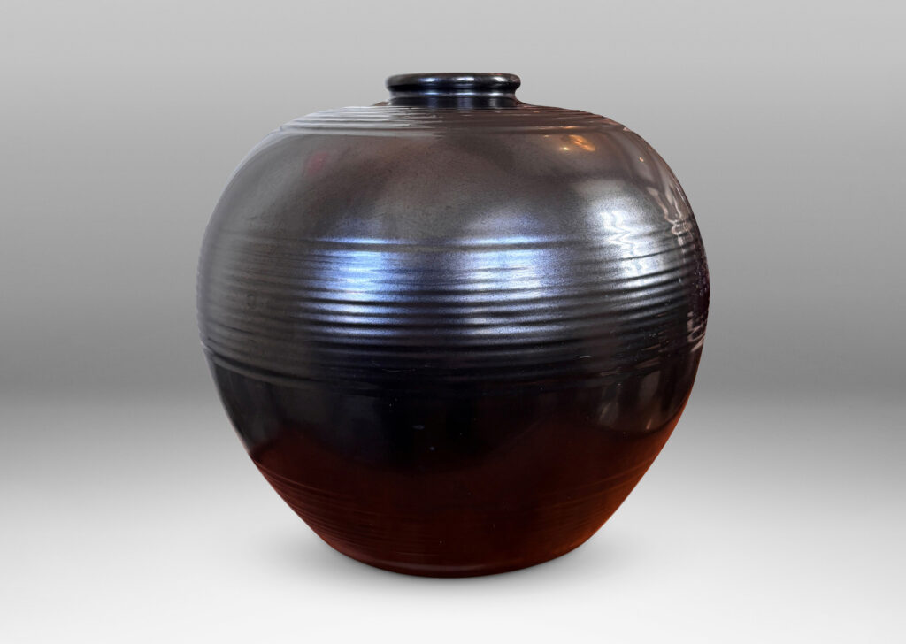 Gallery BAC plump globe form with relief horizontal banding, glazed in a metallic black