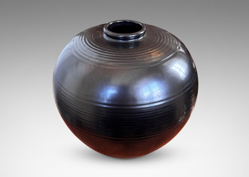 Gallery BAC plump globe form with relief horizontal banding, glazed in a metallic black