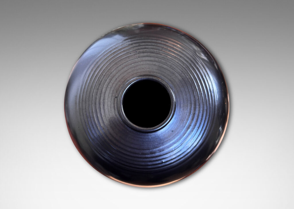 Gallery BAC plump globe form with relief horizontal banding, glazed in a metallic black