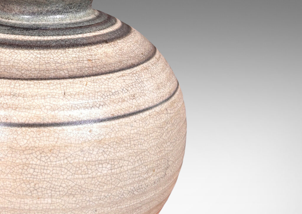 Gallery BAC plump globe forms with sprouting mouths, glazed in craquel greige, with charcoal gray graduated bands and turquoise interiors