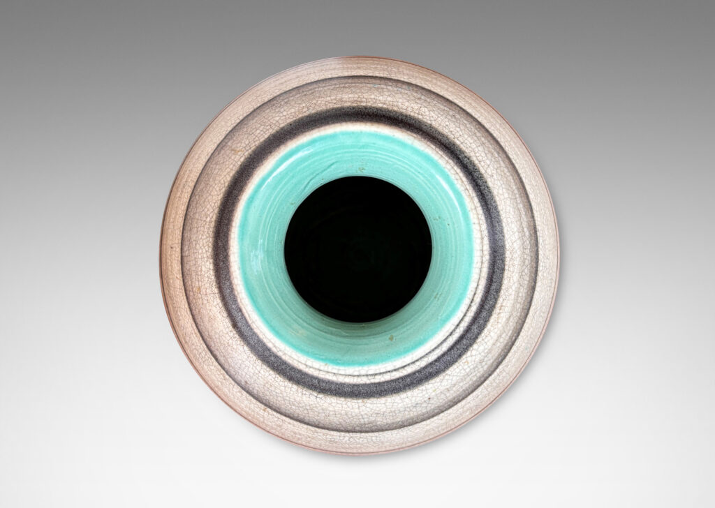 Gallery BAC plump globe forms with sprouting mouths, glazed in craquel greige, with charcoal gray graduated bands and turquoise interiors