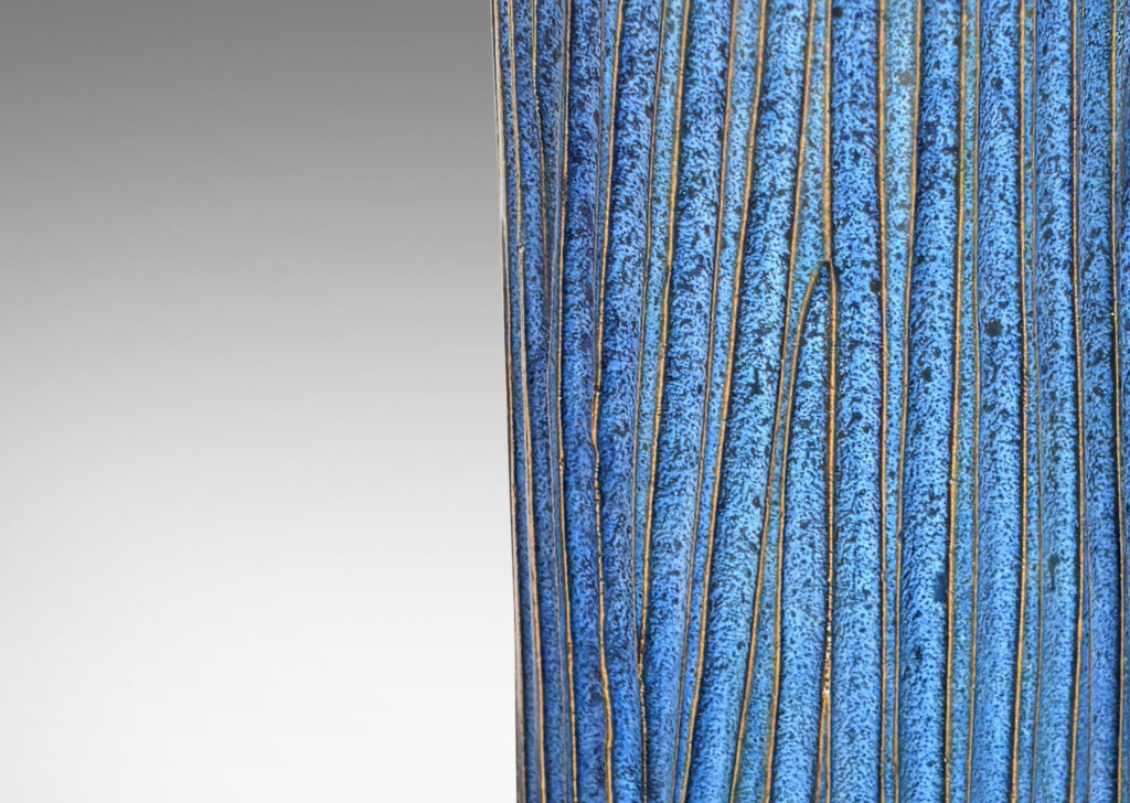 Gallery BAC tall cylindrical form with organically modeled fluting, glazed in an indigo blue