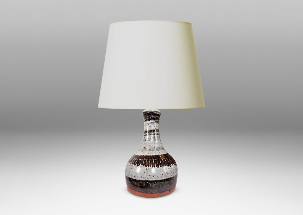 Gallery BAC arge organically modeled pawn / gourd form, glazed in a shiny dappled pale gray with black-red luster bands and strikes