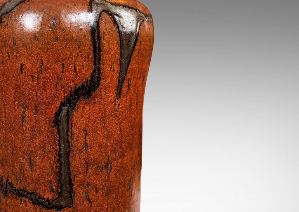 Gallery BAC cylindrical form with swelling shoulders and sprouting neck, glazed in rust-brown with abstract design in gray-red luster