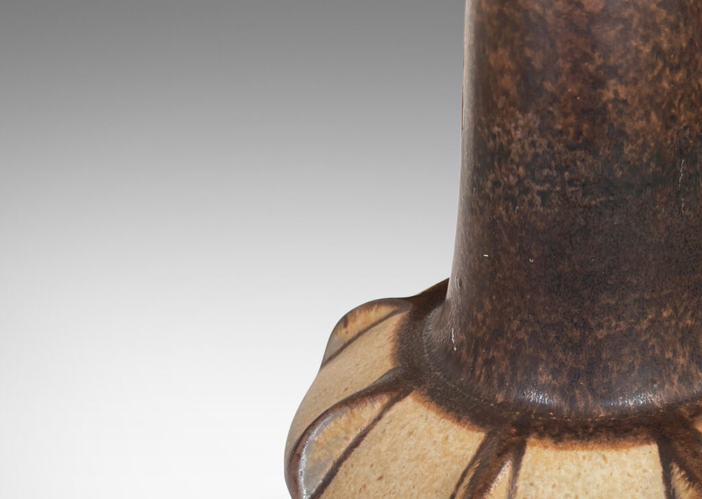 Gallery BAC ow angled and notched form with tall neck, glazed in dark brown with beige