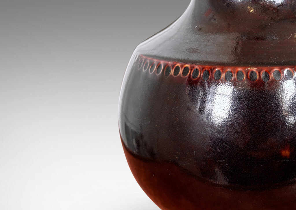 Gallery BAC demi-globe form, with coved neck, wide mouth, and carved beanded detail, glazed in a semi-shine ganache brown