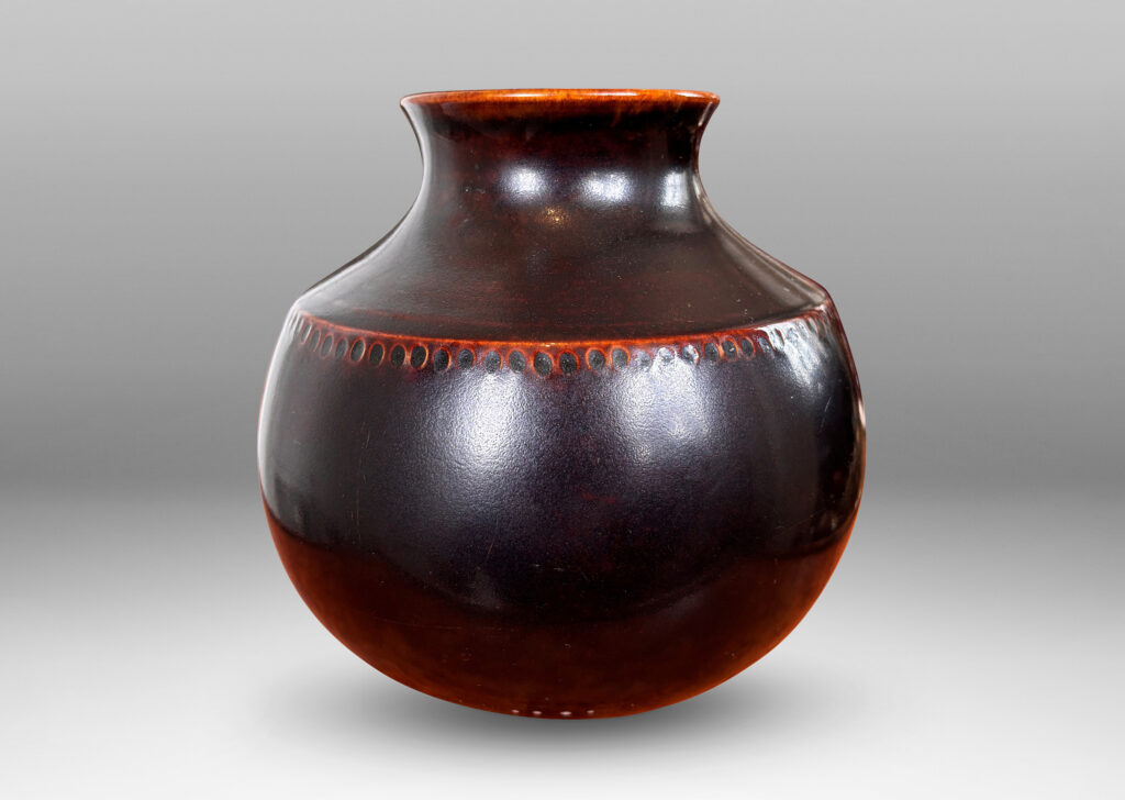 Gallery BAC demi-globe form, with coved neck, wide mouth, and carved beanded detail, glazed in a semi-shine ganache brown