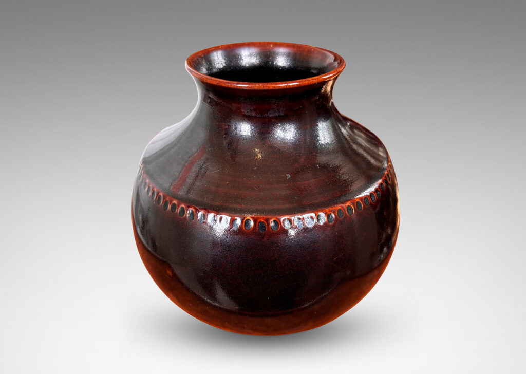 Gallery BAC demi-globe form, with coved neck, wide mouth, and carved beanded detail, glazed in a semi-shine ganache brown
