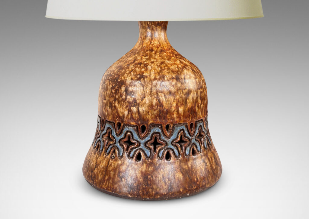 Gallery BAC undulating bell form with carved and openwork ornamental band, glazed in dappled darker overnighter browns, with blue accents