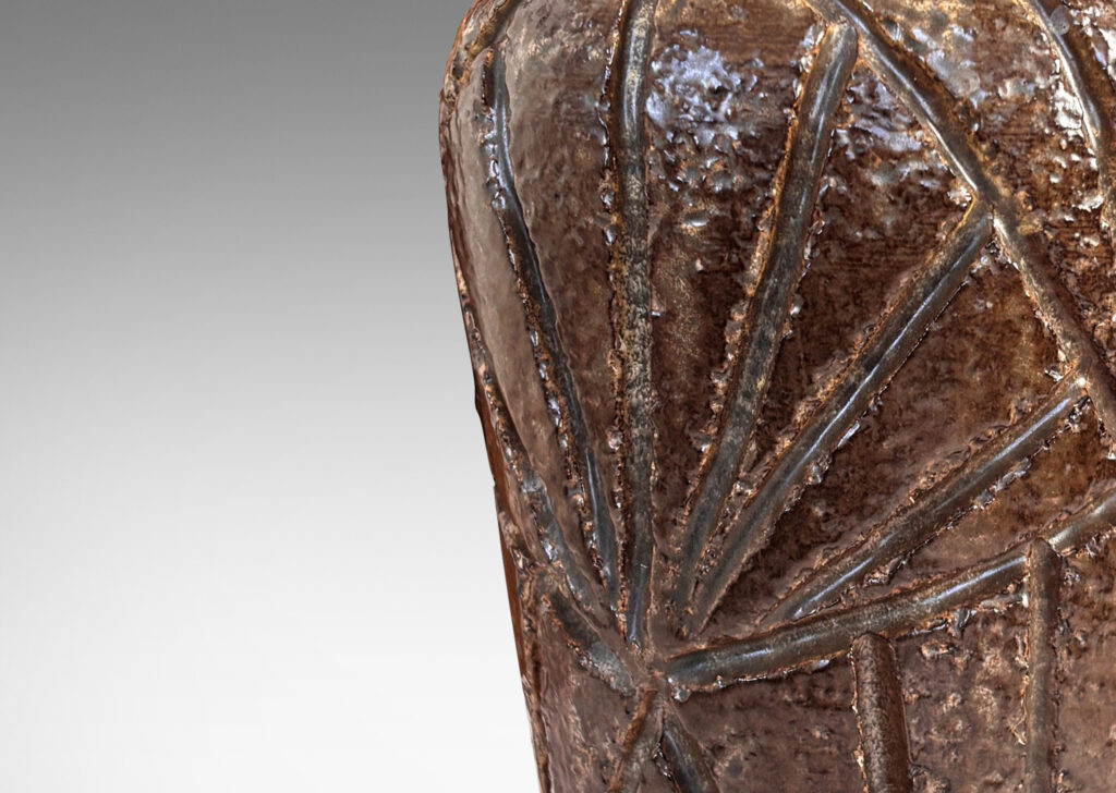 Gallery BAC large tapered form with rugged carved palmate pattern and smooth bead lip, glazed in medium and dark brown