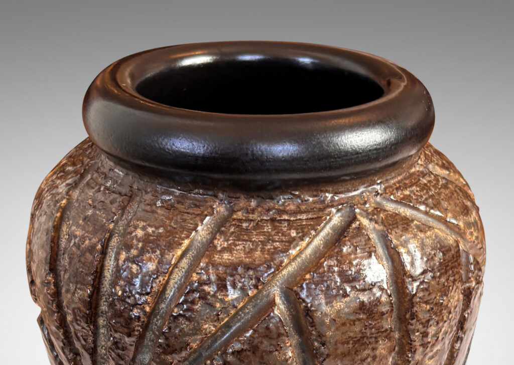 Gallery BAC large tapered form with rugged carved palmate pattern and smooth bead lip, glazed in medium and dark brown