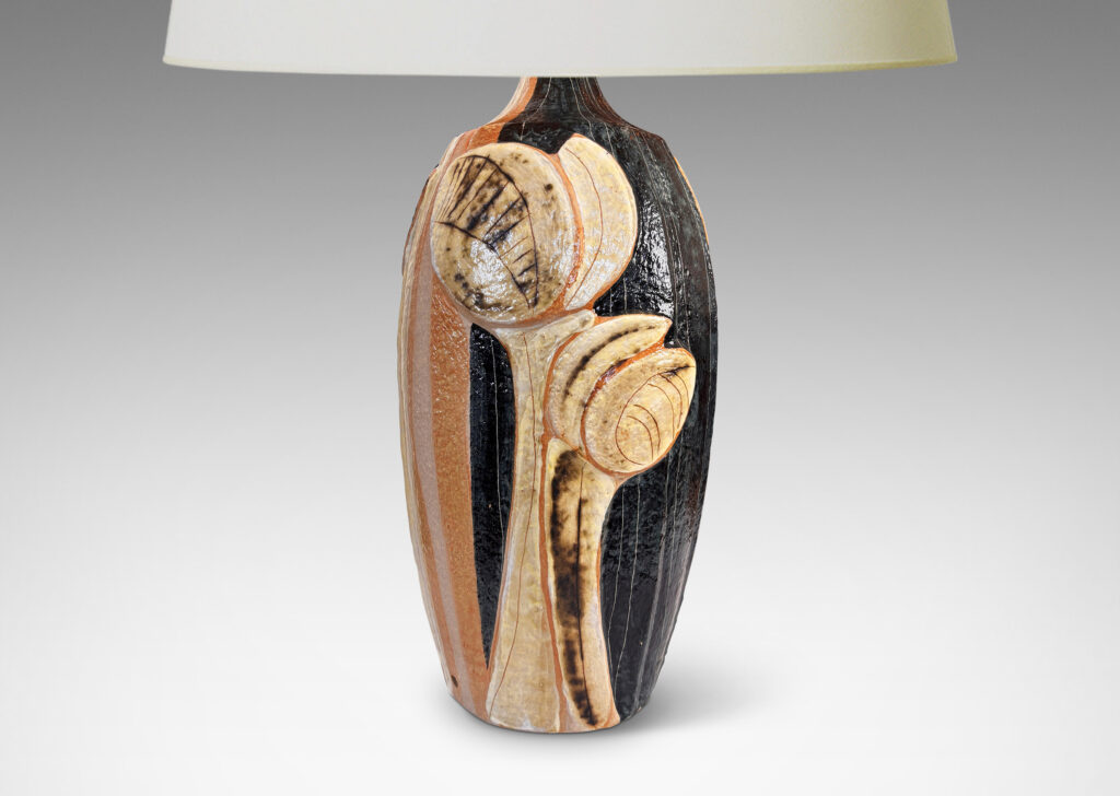 Gallery BAC tall swelling forms with applied relief abstract foliage and coved necks, glazed in ivory, tan, and bluish-black