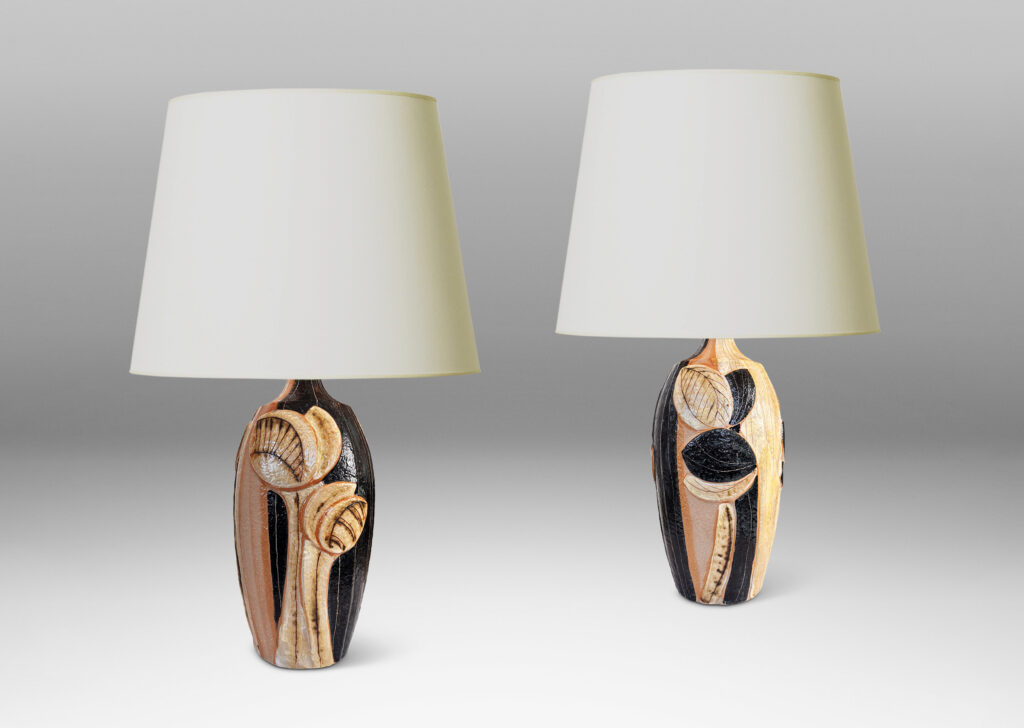 Gallery BAC tall swelling forms with applied relief abstract foliage and coved necks, glazed in ivory, tan, and bluish-black