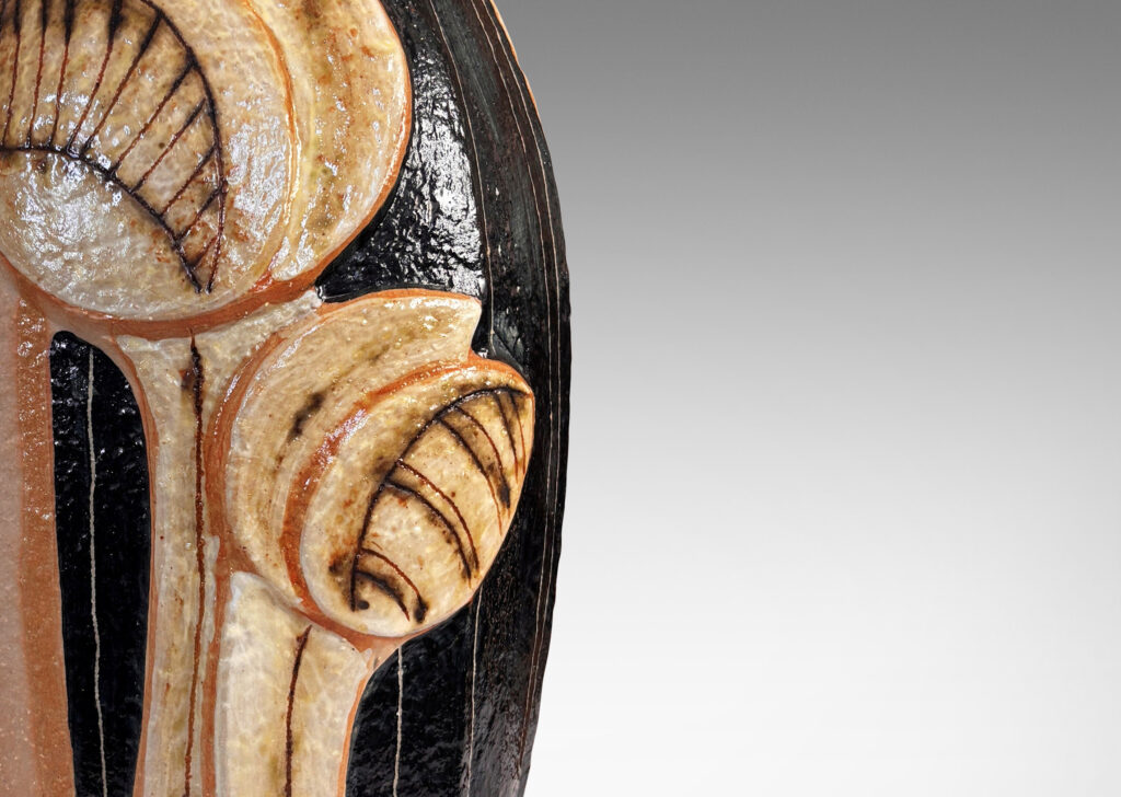 Gallery BAC tall swelling forms with applied relief abstract foliage and coved necks, glazed in ivory, tan, and bluish-black