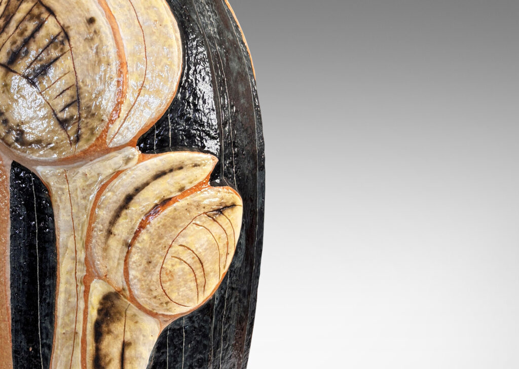 Gallery BAC tall swelling forms with applied relief abstract foliage and coved necks, glazed in ivory, tan, and bluish-black