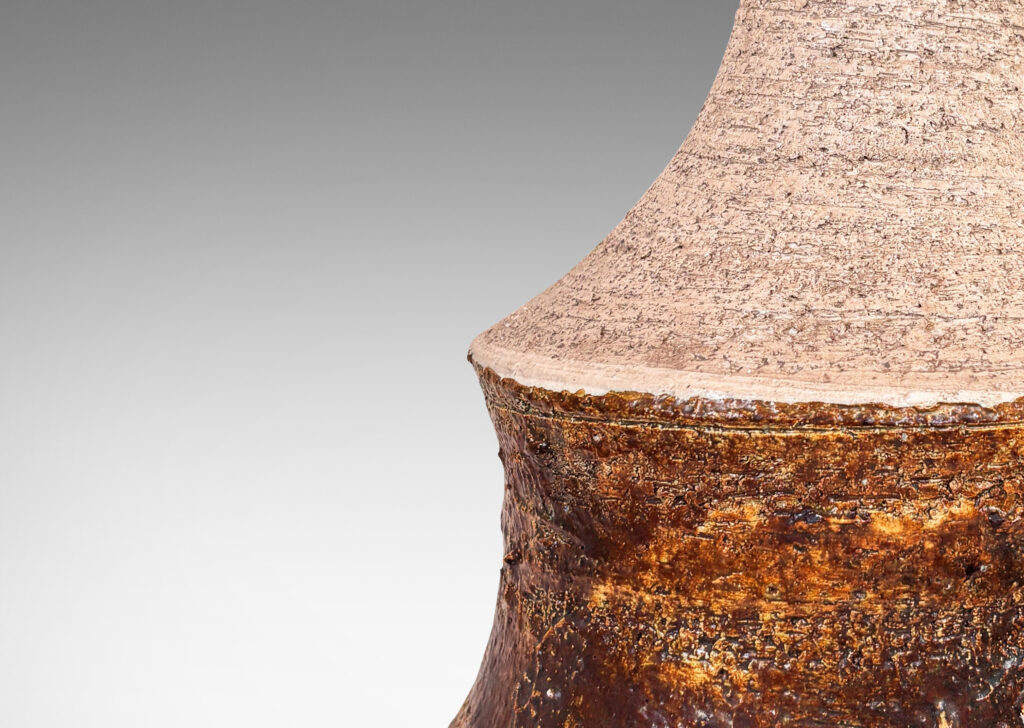 Gallery BAC cove-sided drum form with spouting neck, in textured grog ceramic, glazed in matte ivory and brown