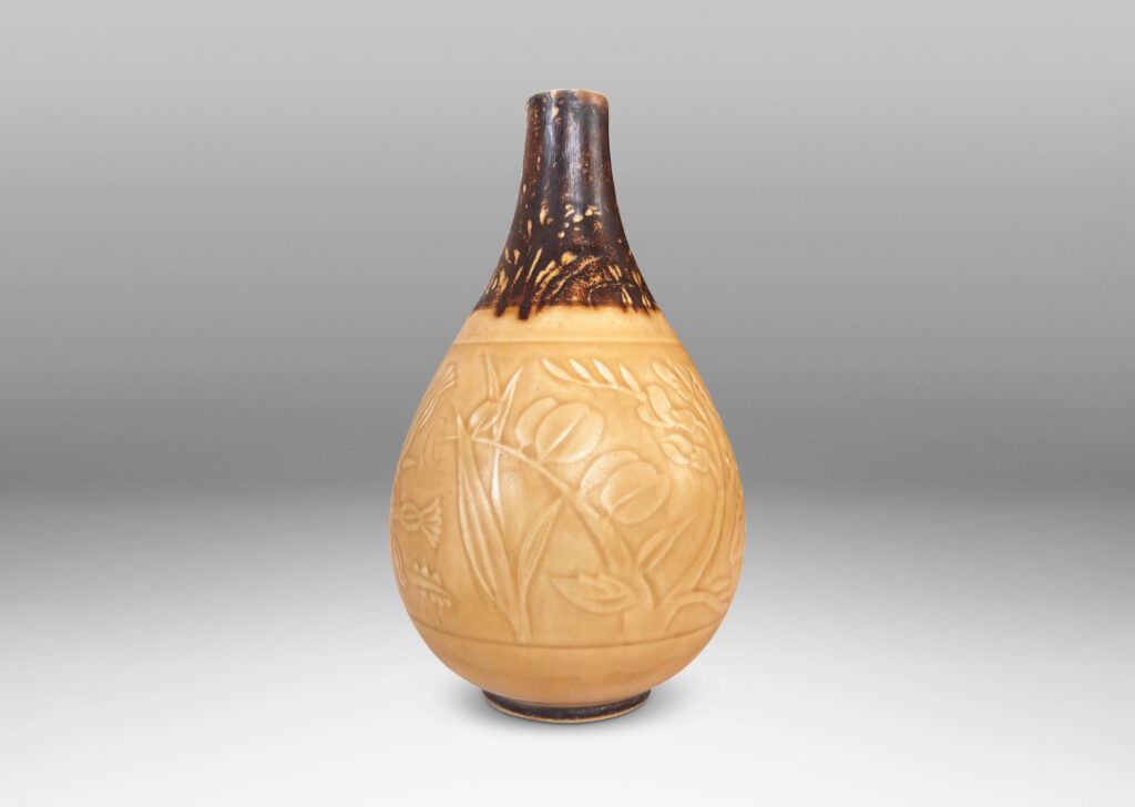 Gallery BAC drop form with floral designs in shallow relief, glazed in pale golden tan and brown