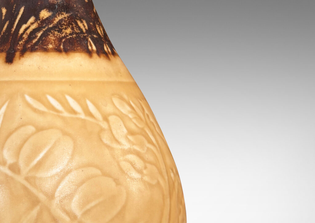 Gallery BAC drop form with floral designs in shallow relief, glazed in pale golden tan and brown