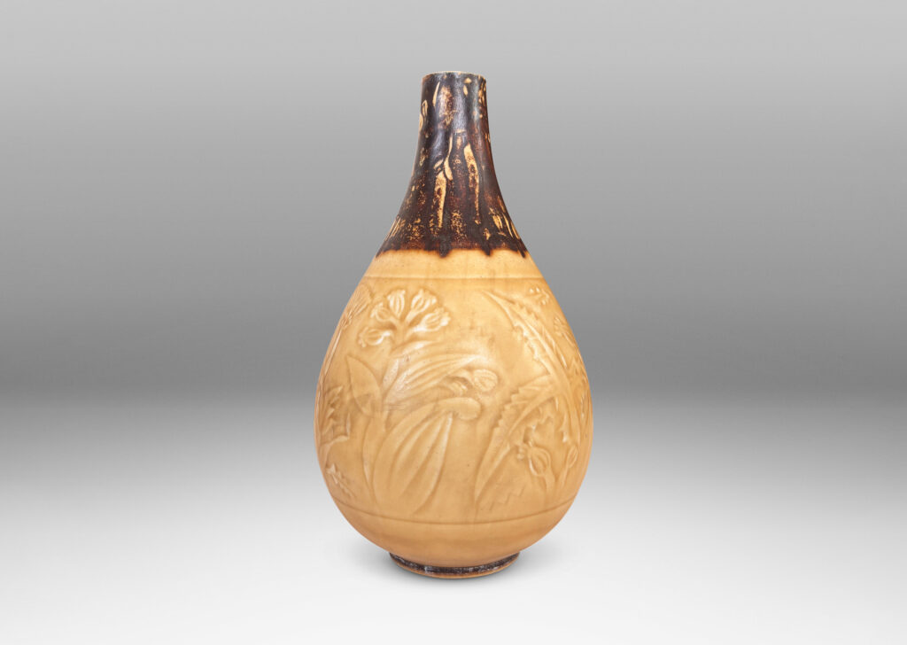 Gallery BAC drop form with floral designs in shallow relief, glazed in pale golden tan and brown