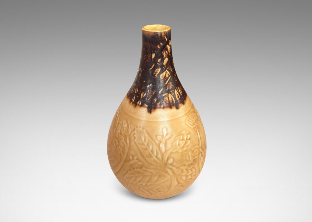 Gallery BAC drop form with floral designs in shallow relief, glazed in pale golden tan and brown