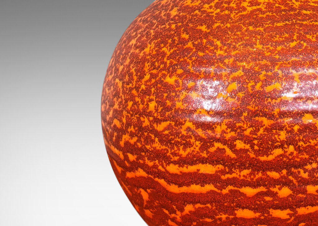 Gallery BAC plump globe form, glazed in a mottled burnt orange dapple over lighter orange “Korall” (coral) glazing