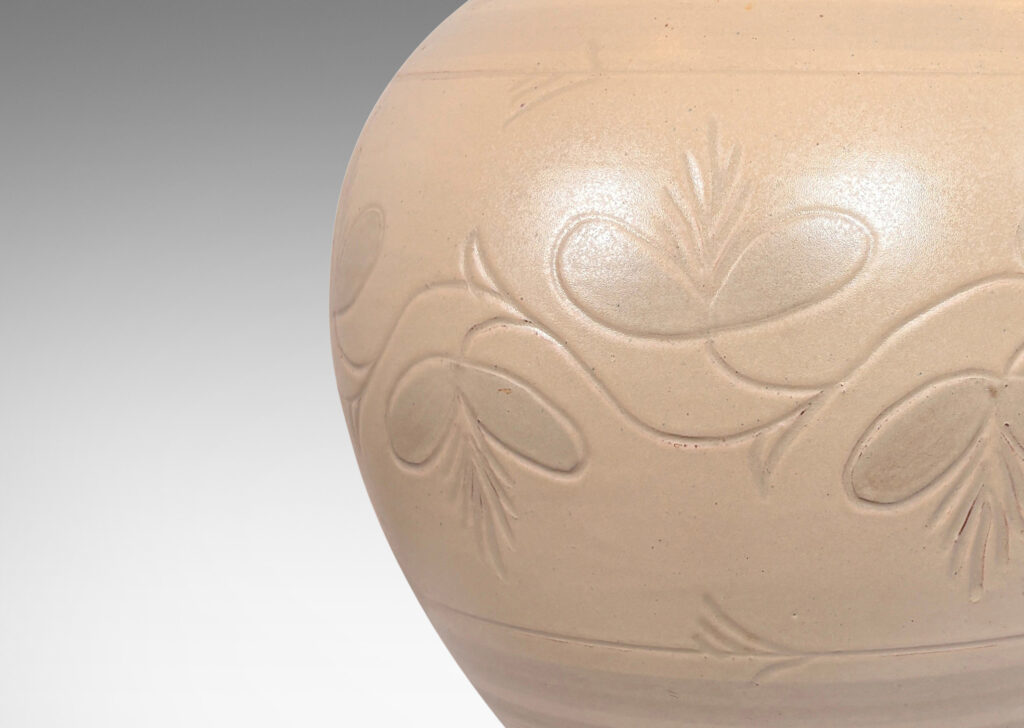 Gallery BAC tapered globe form with carved pinstripe bands and folk style floral ornaments, glazed in an eggshell ivory