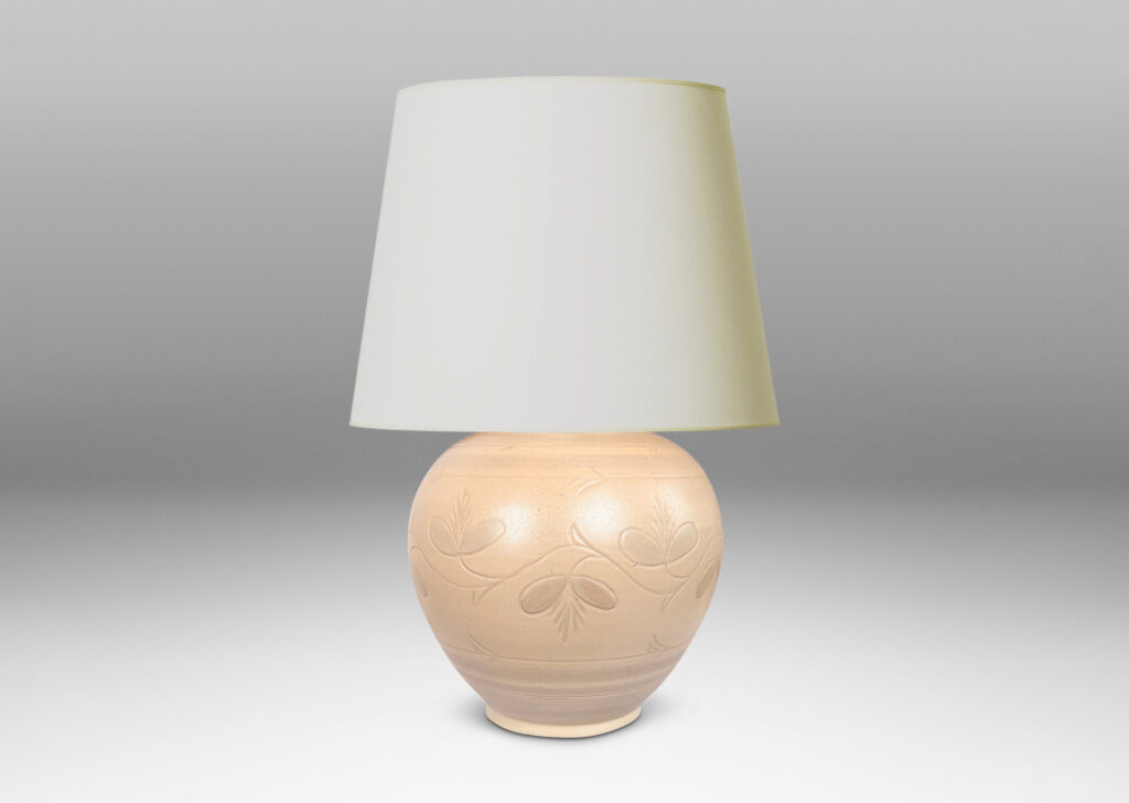 Gallery BAC tapered globe form with carved pinstripe bands and folk style floral ornaments, glazed in an eggshell ivory