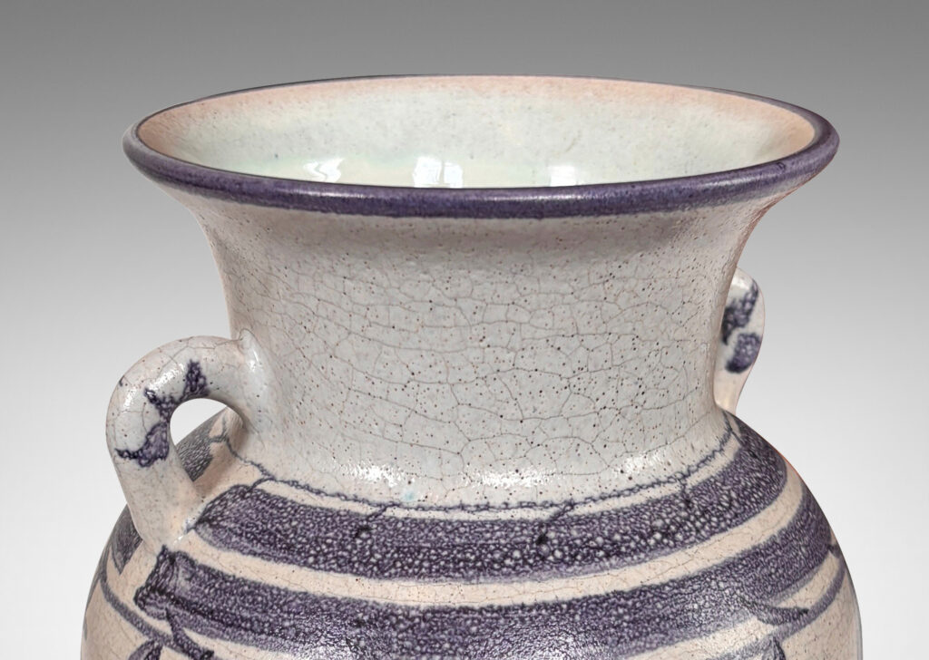 Gallery BAC tapered urn for with wide outstretching mouth and loop handels, in pale craquel gray overglazed with blue-purple bands and foliate designs