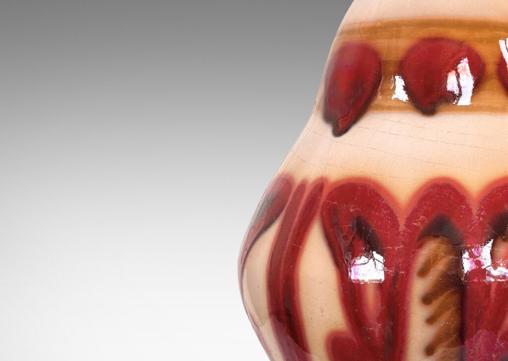 Gallery BAC undulating ginger jar-like form with sprouting neck, glazed in glossy burgundy and brown over beige
