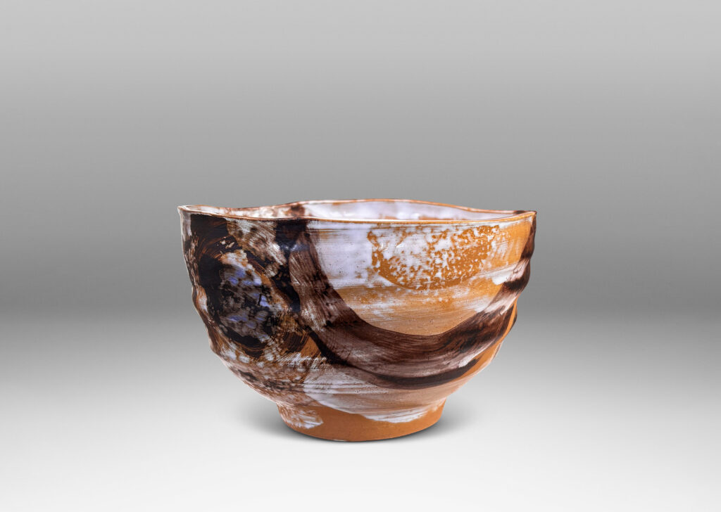 Gallery BAC thin, ridged form, glazed in flowing brown and white over tan