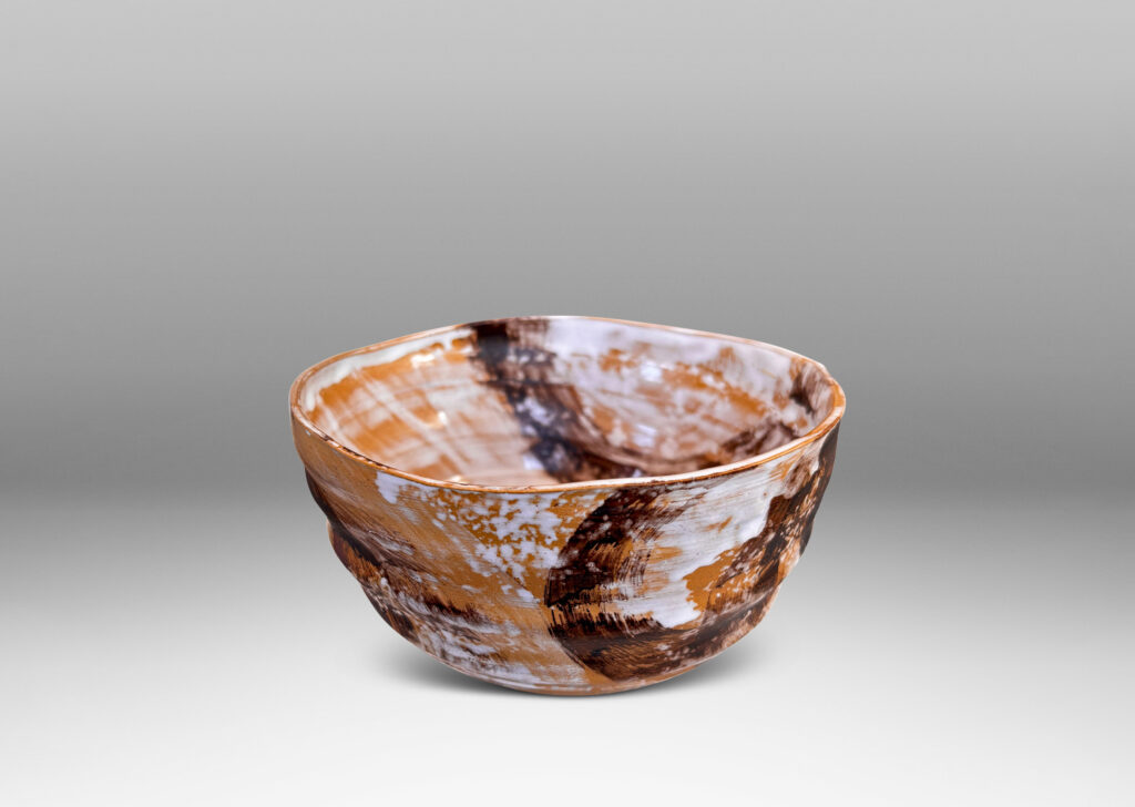 Gallery BAC thin, ridged form, glazed in flowing brown and white over tan