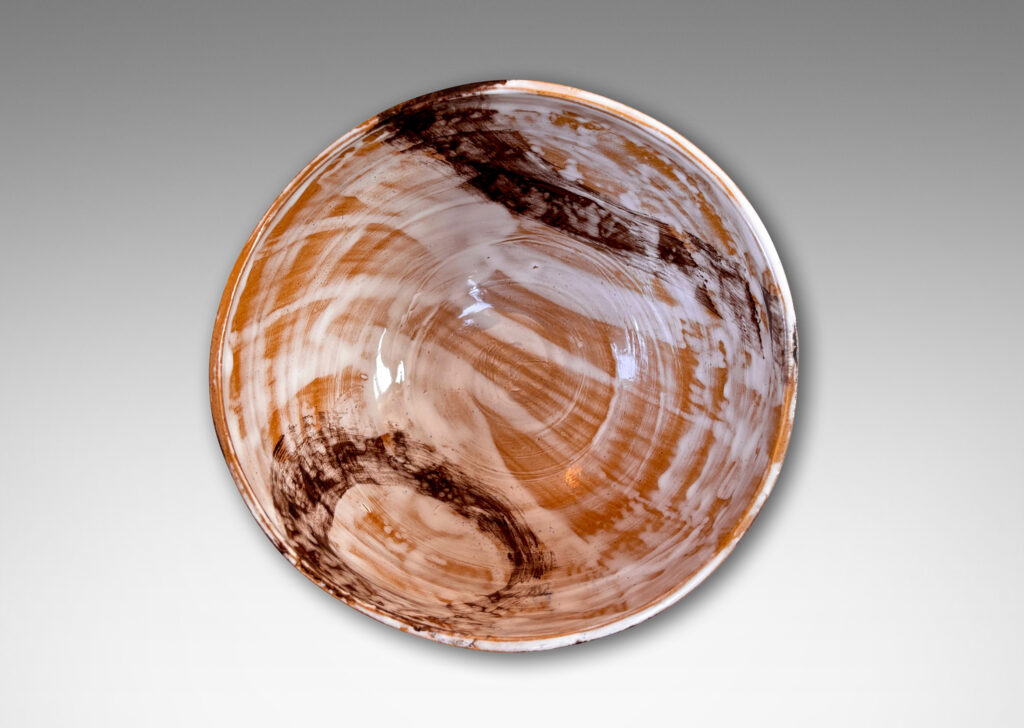 Gallery BAC thin, ridged form, glazed in flowing brown and white over tan