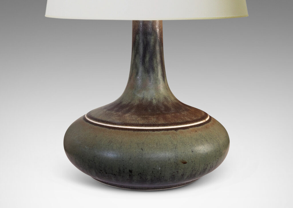 Gallery BAC decanter-like form with a wide compressed base and sprouting neck; glazed in a flowing dark green tones