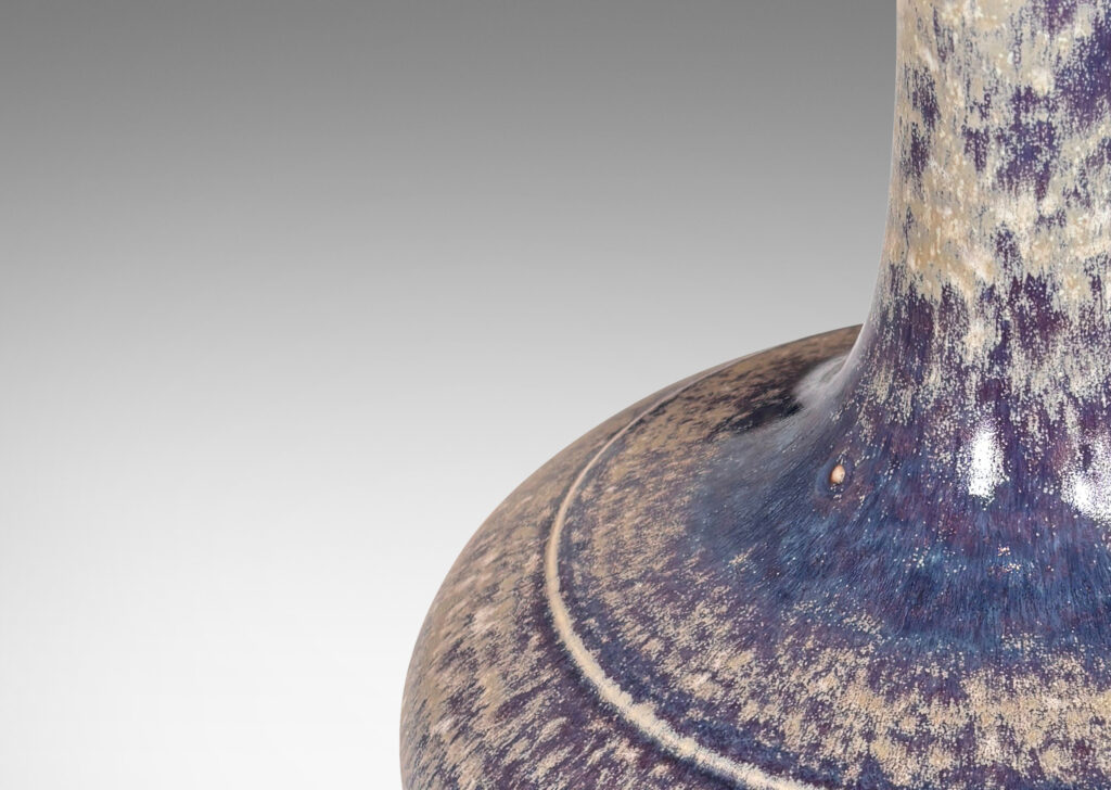 Gallery BAC decanter-like form with a wide compressed base and sprouting neck; glazed in purple and pale gray