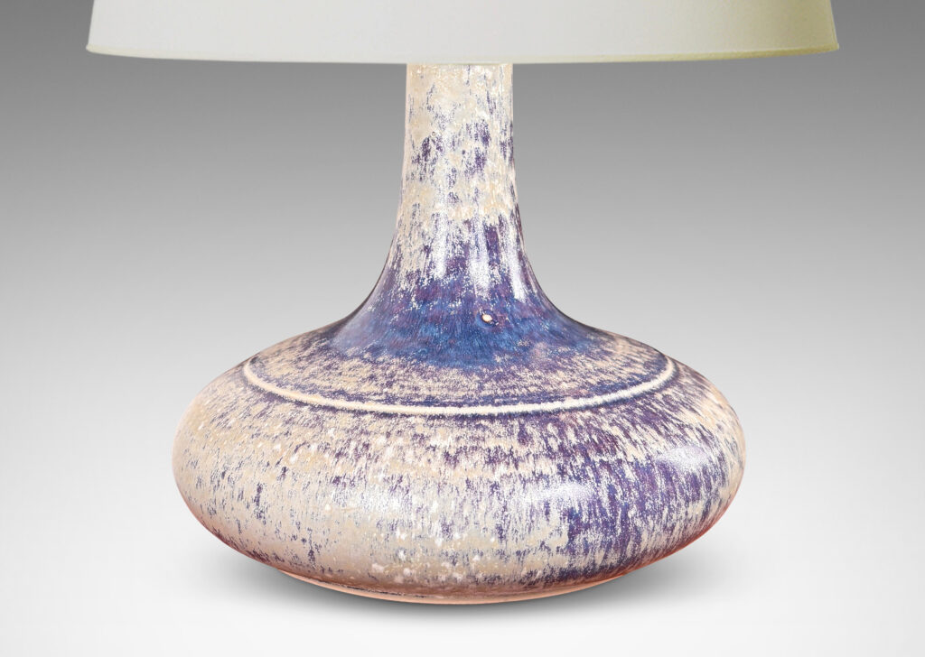 Gallery BAC decanter-like form with a wide compressed base and sprouting neck; glazed in purple and pale gray