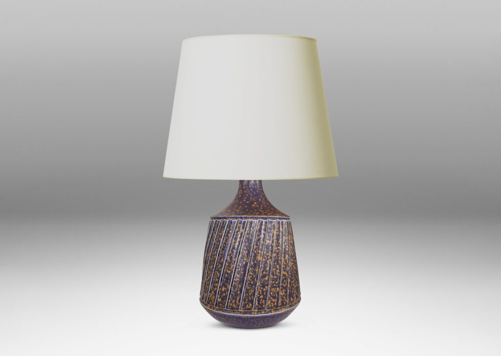 Gallery BAC raked drum form with sprouting neck and carved diagonal ridge design; glazed in sponged dark blue