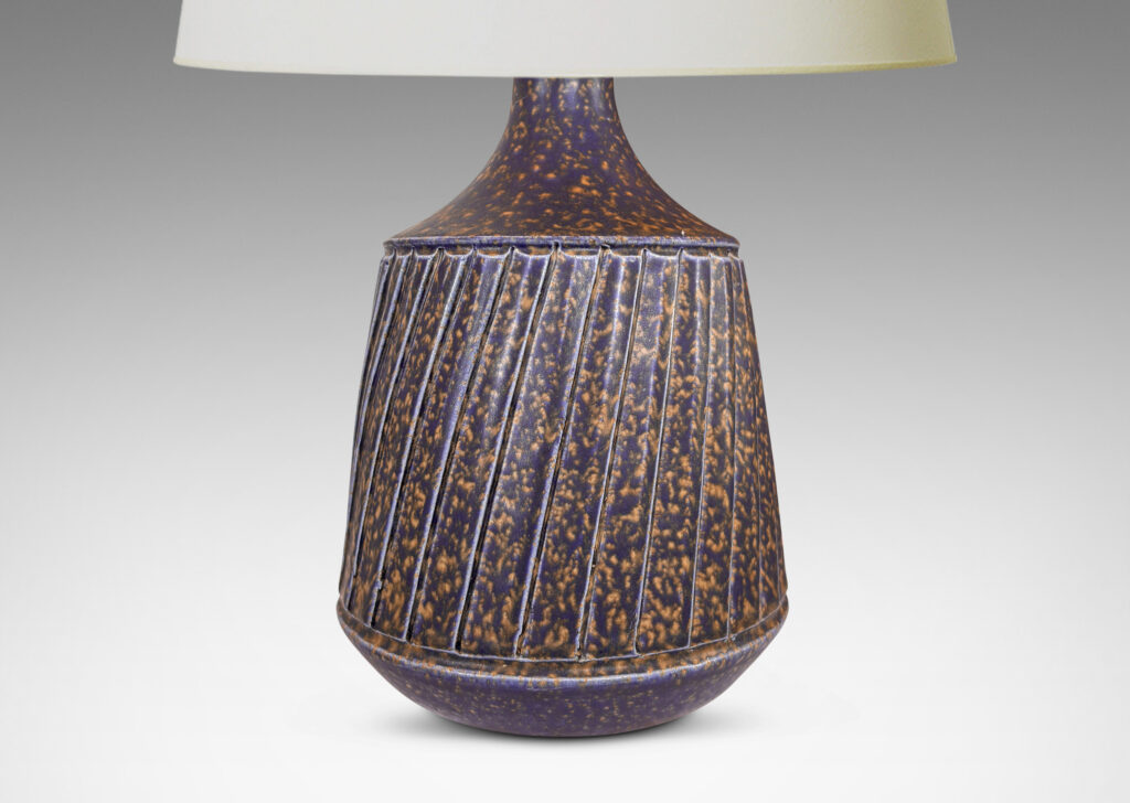 Gallery BAC raked drum form with sprouting neck and carved diagonal ridge design; glazed in sponged dark blue