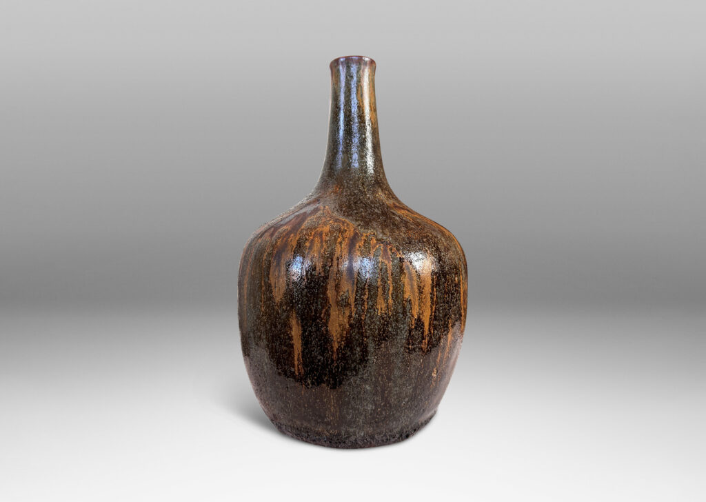 Gallery BAC apple-like form with tall slender neck, glazed in flowing matte light and dark brown over shiny black and gray