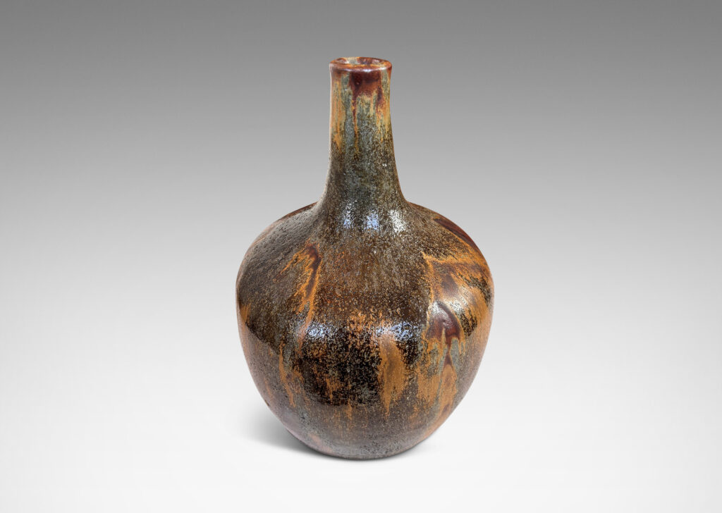 Gallery BAC apple-like form with tall slender neck, glazed in flowing matte light and dark brown over shiny black and gray