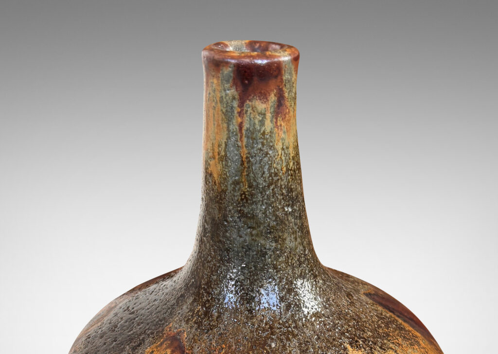 Gallery BAC apple-like form with tall slender neck, glazed in flowing matte light and dark brown over shiny black and gray