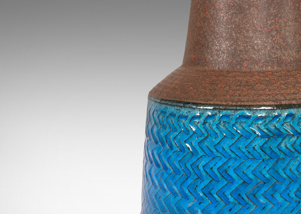 Gallery BAC drum form encircled in impressed chevron pattern and tall conical neck, glazed in a matte dark brown and luminous gloss azure blue