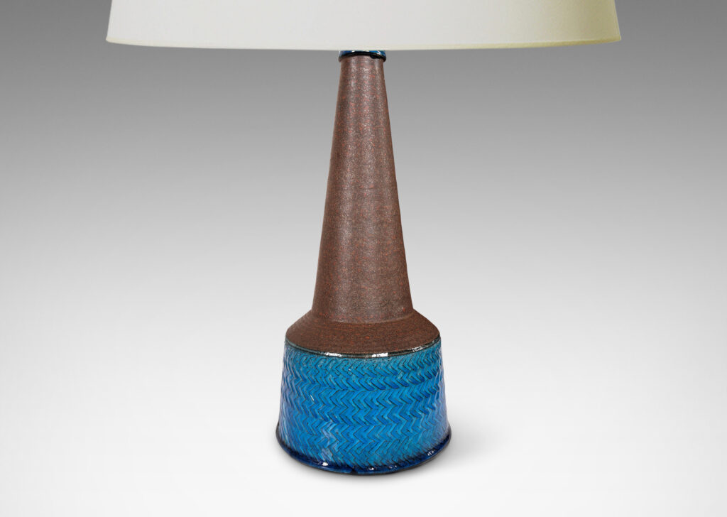 Gallery BAC drum form encircled in impressed chevron pattern and tall conical neck, glazed in a matte dark brown and luminous gloss azure blue