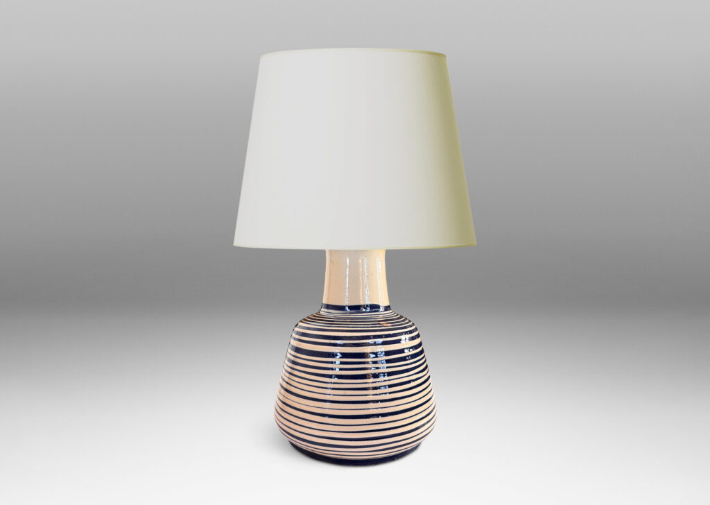 Gallery BAC angled drum form, wide neck and flange top, glazed in ivory with spiraling pinstripes in dark blue