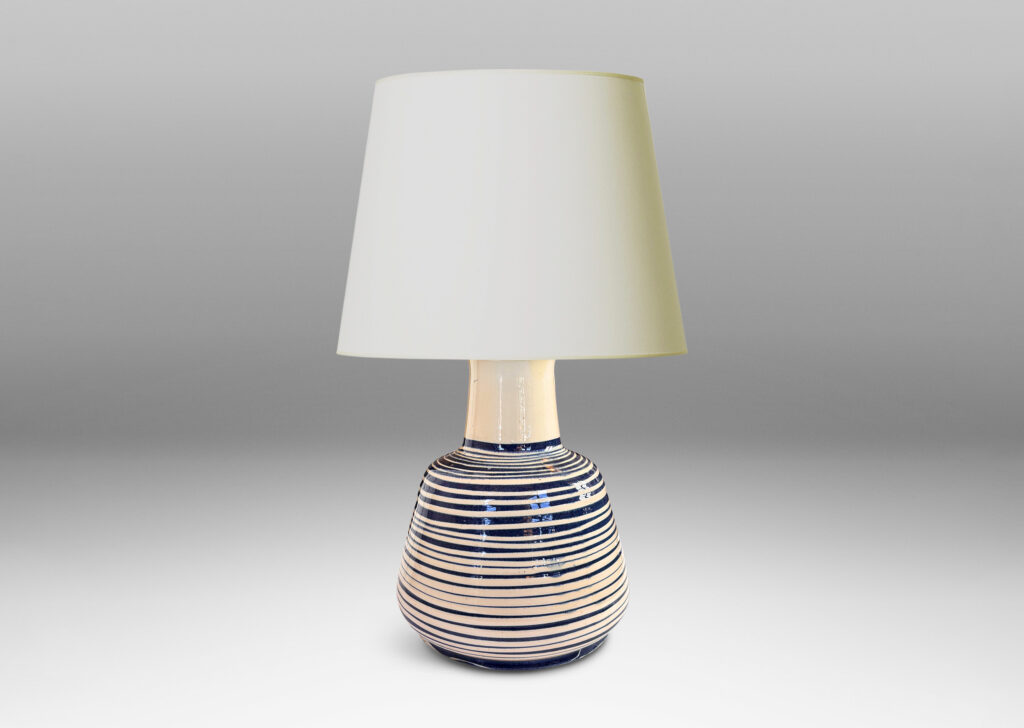 Gallery BAC angled drum form, wide neck and flange top, glazed in ivory with spiraling pinstripes in dark blue