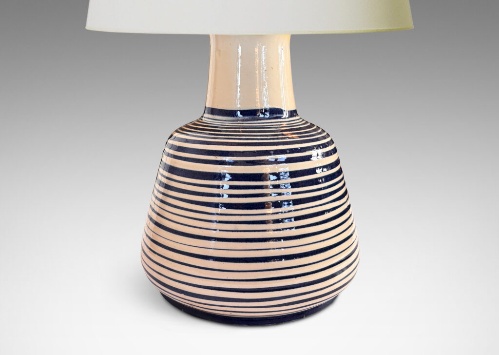 Gallery BAC angled drum form, wide neck and flange top, glazed in ivory with spiraling pinstripes in dark blue