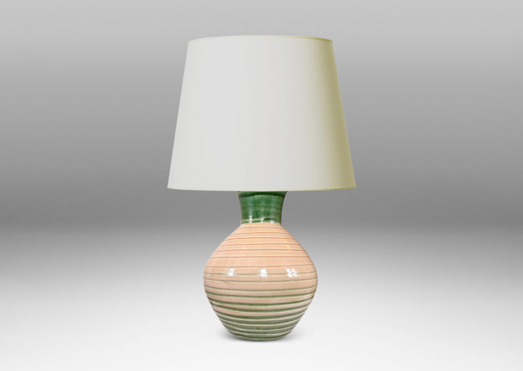 Gallery BAC globe form with wide neck and carved spiraling ridges, glazed in shiny ivory, with green neck and partial pinstripes