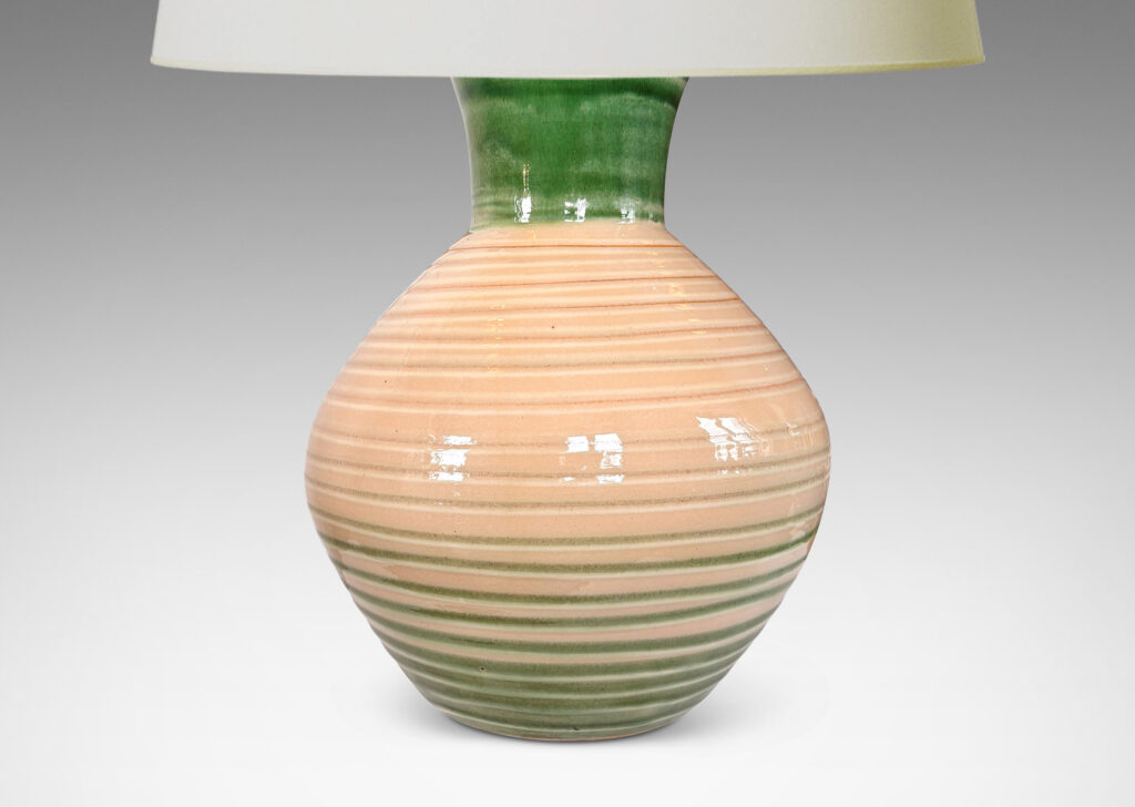 Gallery BAC globe form with wide neck and carved spiraling ridges, glazed in shiny ivory, with green neck and partial pinstripes