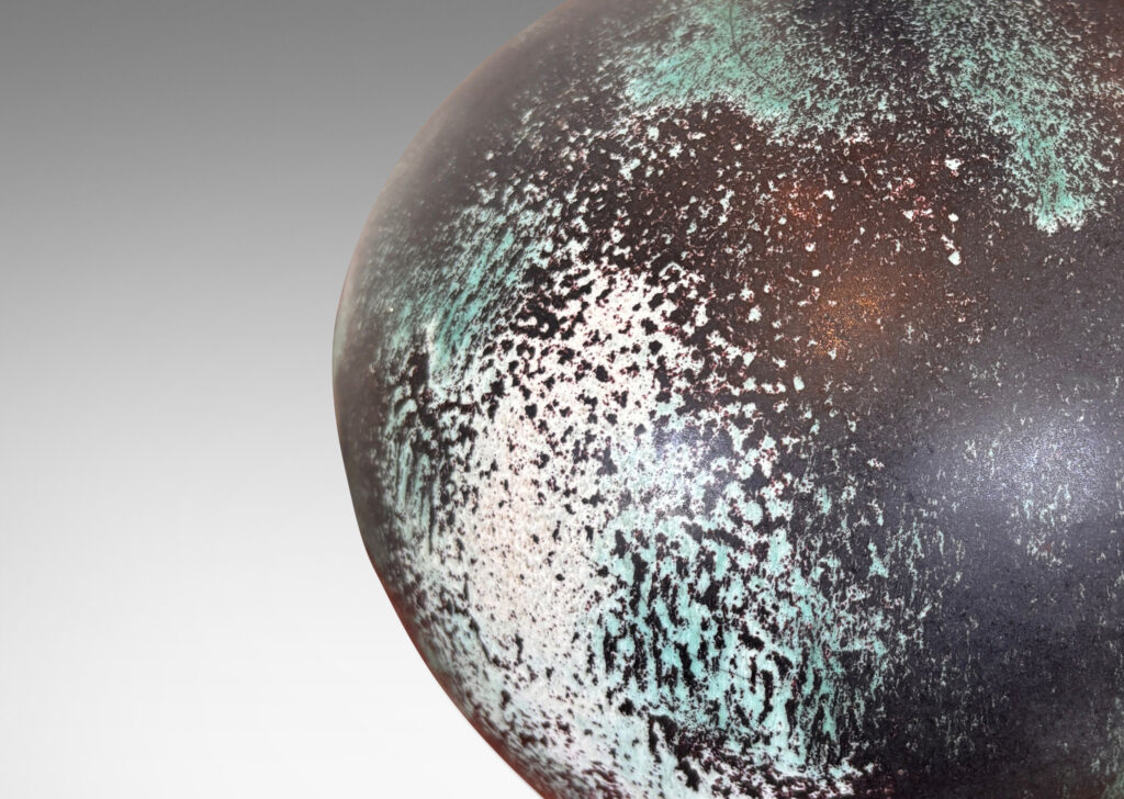 Gallery BAC plump globe form, glazed in a matte black with airy blushes of white and blue-green