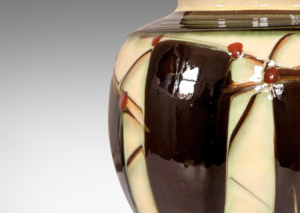 Gallery BAC globe form with angled shoulder and outstretched mouth with brass rim, decorated with a shiny glaze geometric design