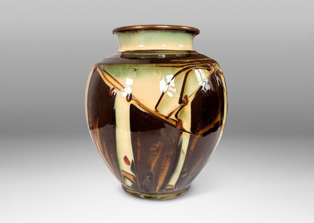 Gallery BAC globe form with angled shoulder and outstretched mouth with brass rim, decorated with a shiny glaze geometric design